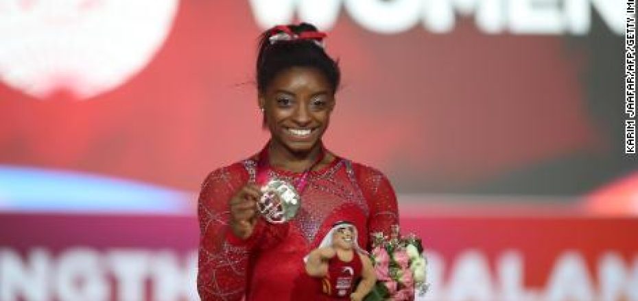 Gold medallist Simone Biles (C) from the US poses for a photograph with her medal after the Floor Exercise final during the 2018 FIG Artistic Gymnastics Championships at the Aspire Dome on November 3, 2018 in Doha. (Photo by KARIM JAAFAR / AFP)KARIM JAAFAR/AFP/Getty Images