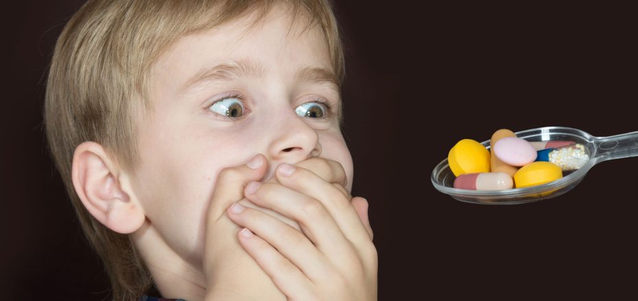 30512477 - boy refusing to take medicine on a spoon