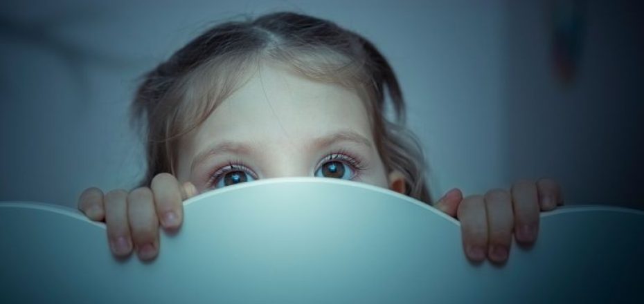 child-peeking-above-headboard-768