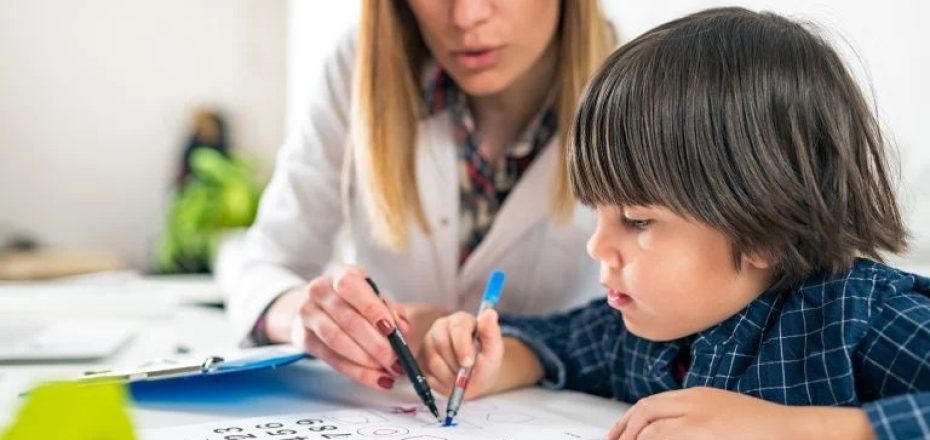 young-woman-works-with-boy-on-markable-chart-768